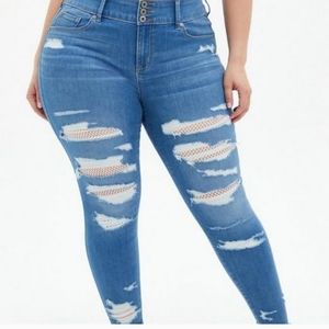 TORRID Distressed Jeggings with white fishnet underlay